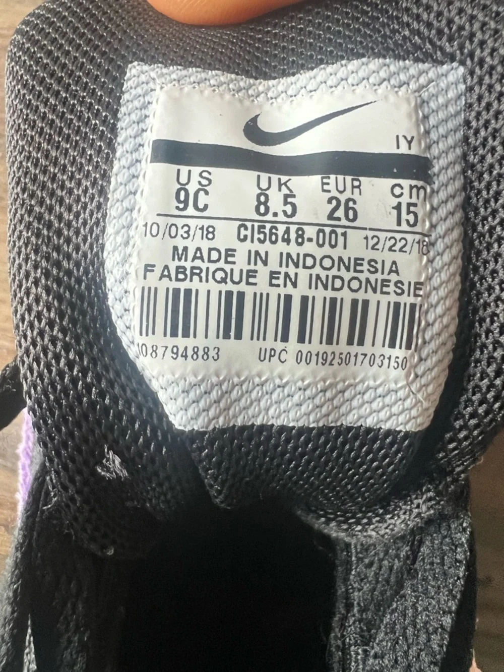 Nike Kids Black Sneakers with Purple Trim and Teal Logo